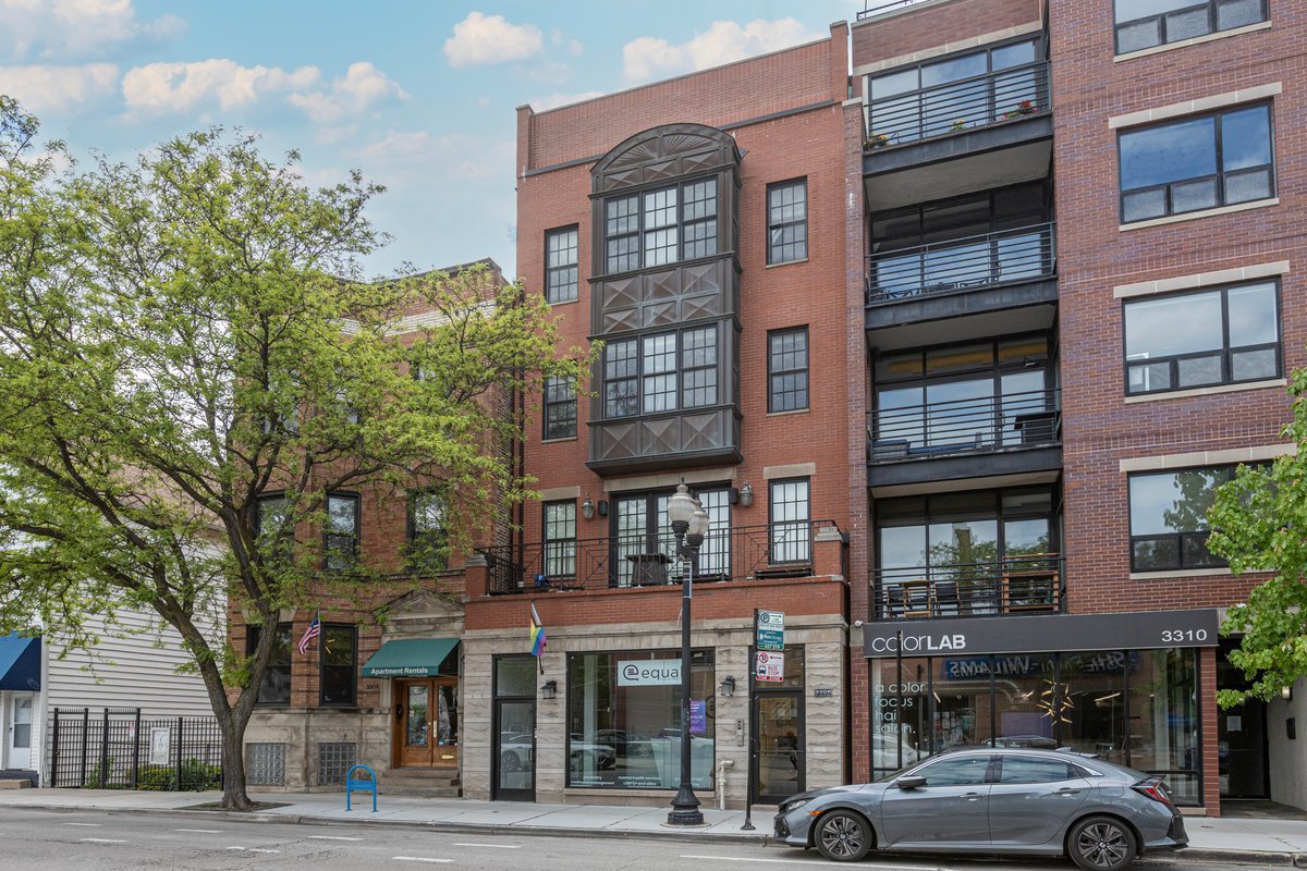 3306 North Halsted Street, Unit 3 Chicago, IL 60657 - Photo 1 of 1 a front view of a building and car parked