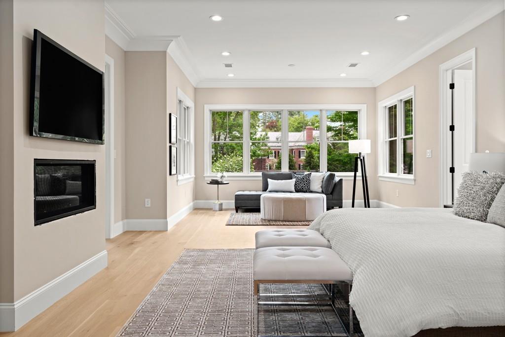 46 Exeter Street Newton, MA 02465 - Photo 16 of 40 a bedroom with a large bed and a flat tv screen