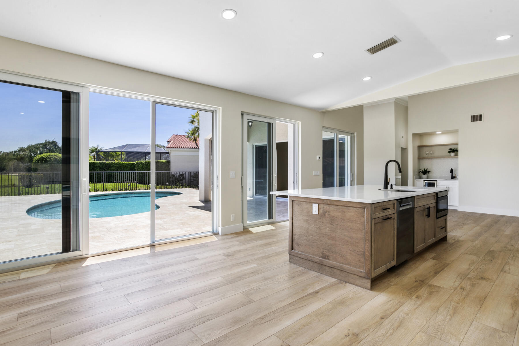 15810 Windrift Drive Jupiter, FL 33477 - Photo 11 of 52 a view of kitchen with granite countertop attached living room