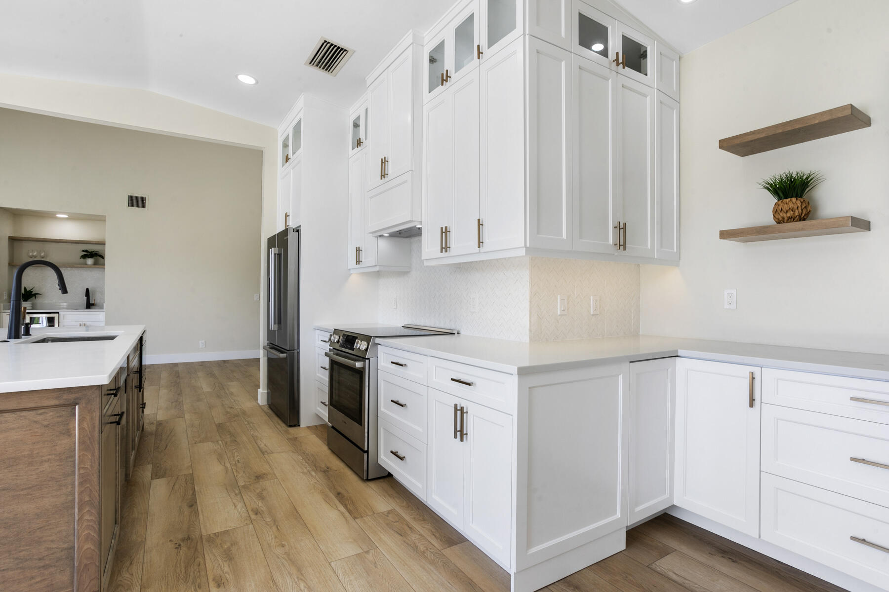 15810 Windrift Drive Jupiter, FL 33477 - Photo 12 of 52 a kitchen with granite countertop a sink stainless steel appliances and cabinets