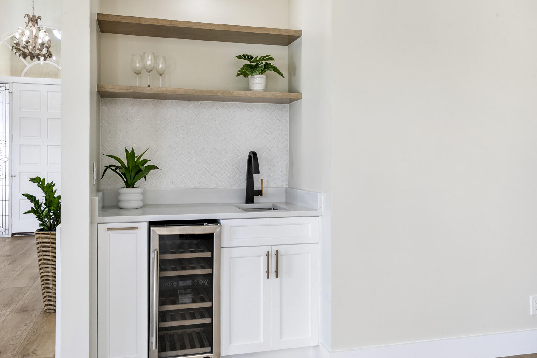 15810 Windrift Drive Jupiter, FL 33477 - Photo 14 of 52 a bathroom with a sink a potted plant and a wooden floor