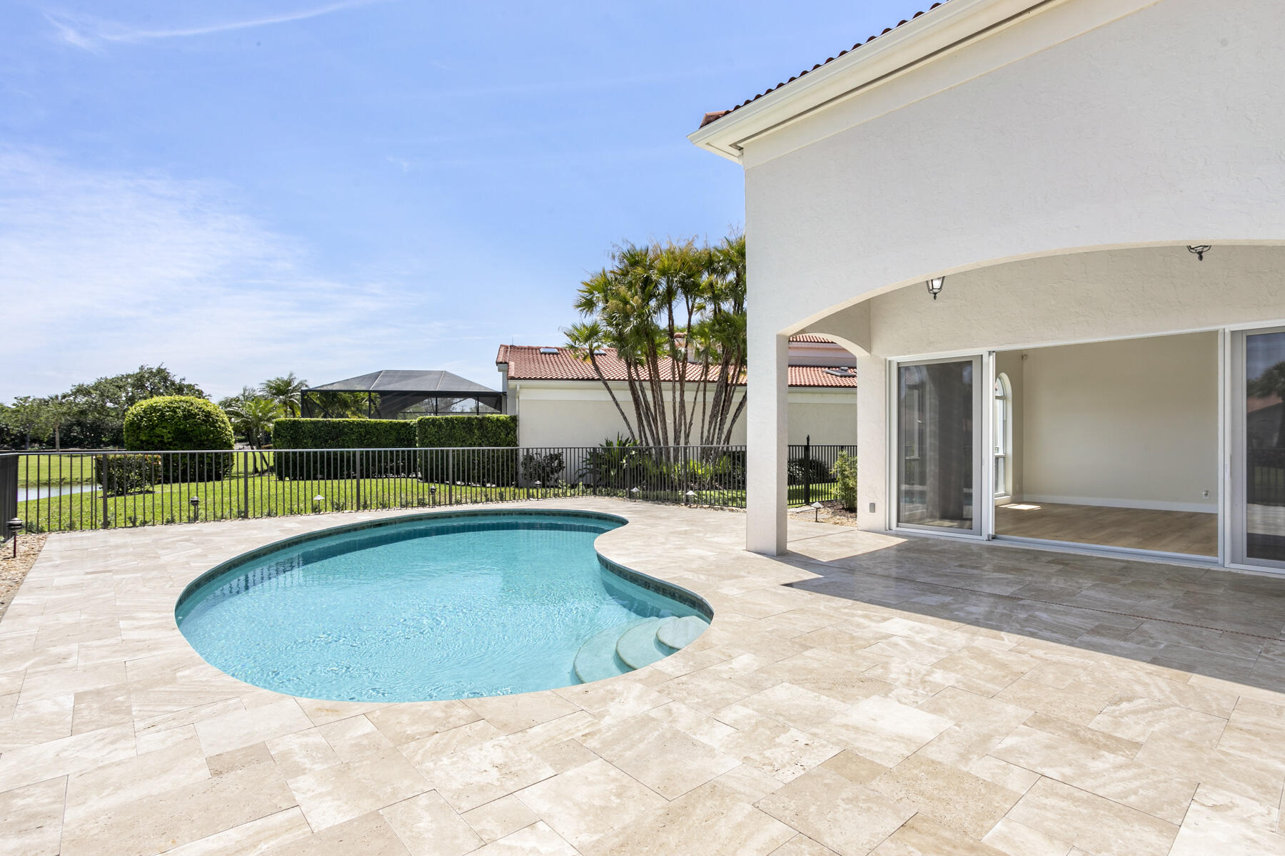 15810 Windrift Drive Jupiter, FL 33477 - Photo 16 of 52 a view of a swimming pool with a lounge chair