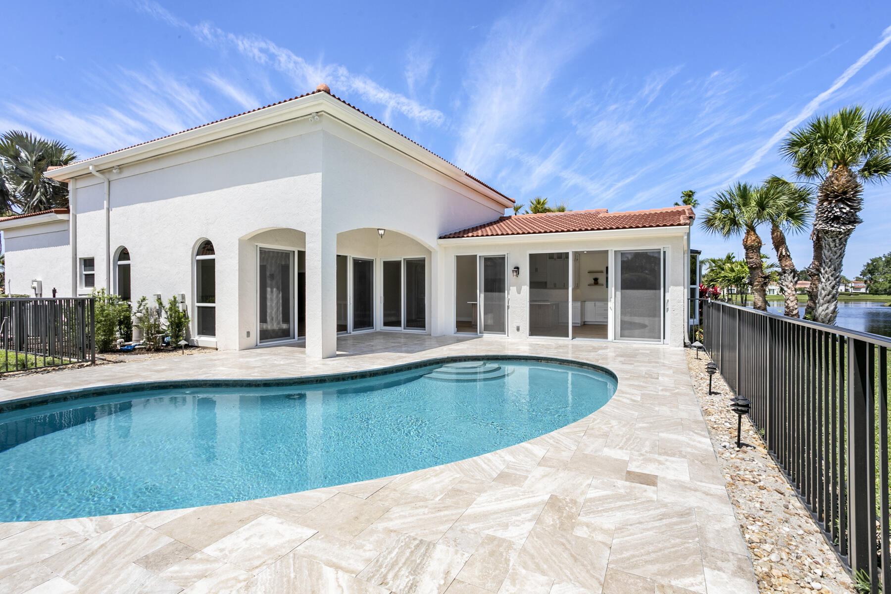 15810 Windrift Drive Jupiter, FL 33477 - Photo 17 of 52 a view of a house with pool and chairs