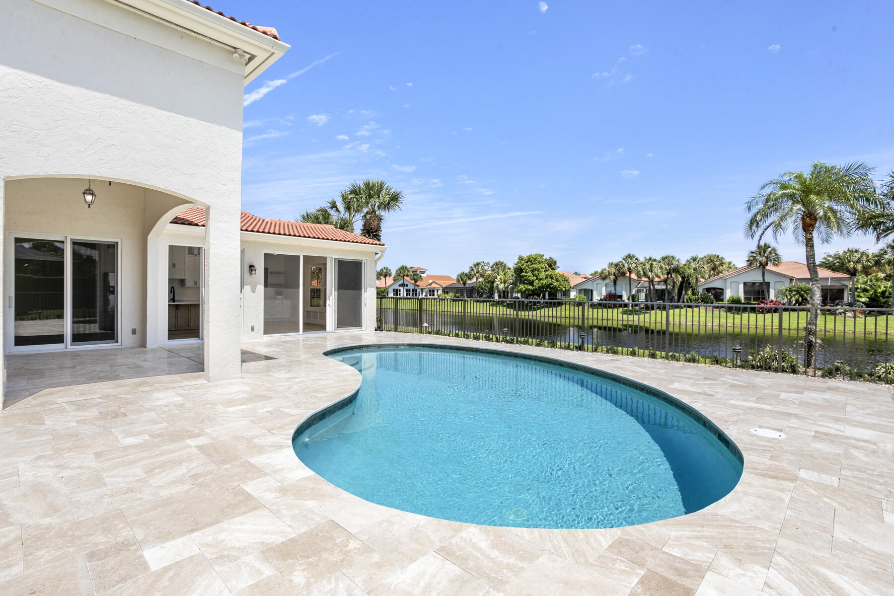 15810 Windrift Drive Jupiter, FL 33477 - Photo 18 of 52 a view of a swimming pool and a yard