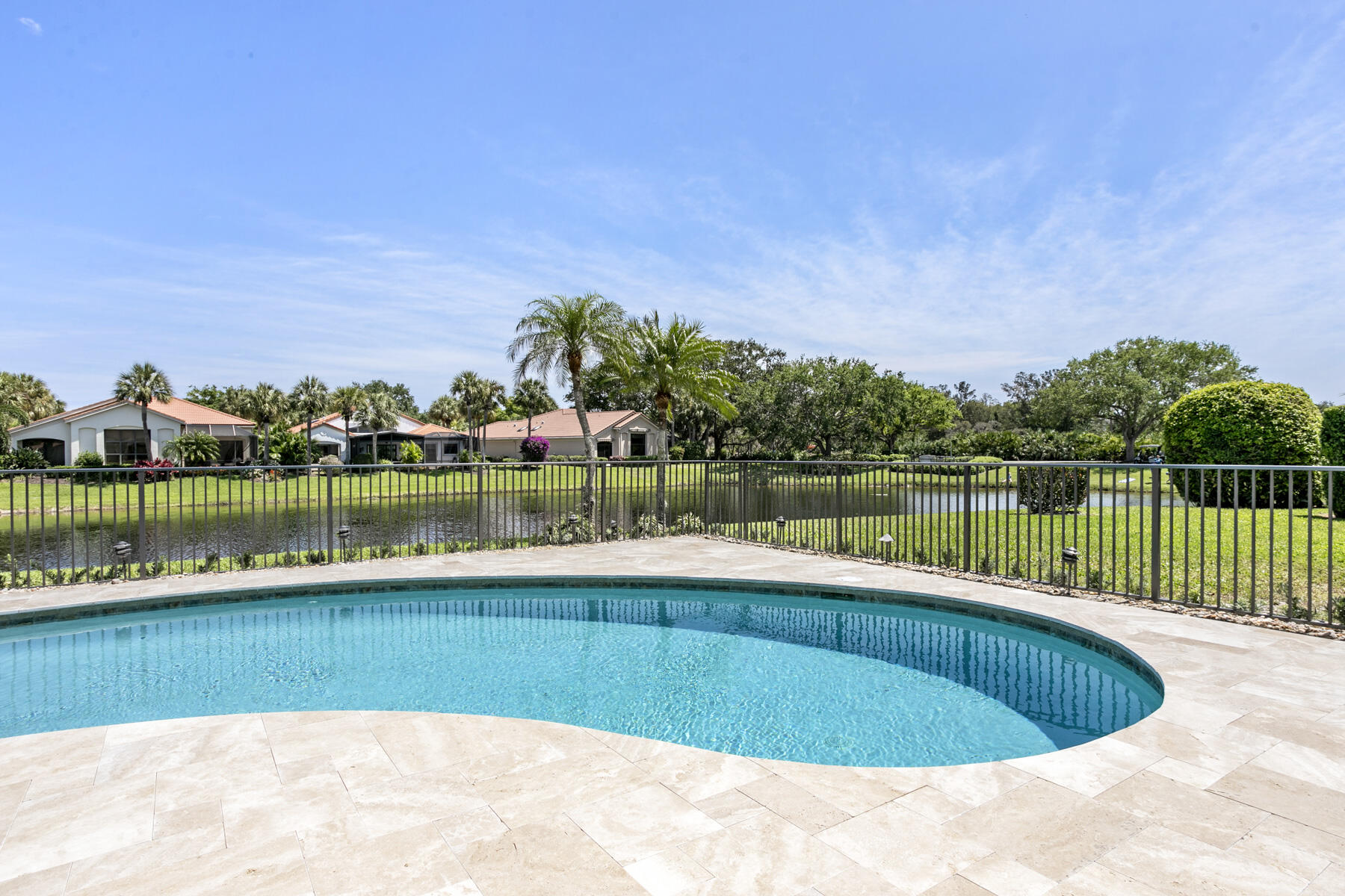15810 Windrift Drive Jupiter, FL 33477 - Photo 19 of 52 a view of a lake with a house in the background