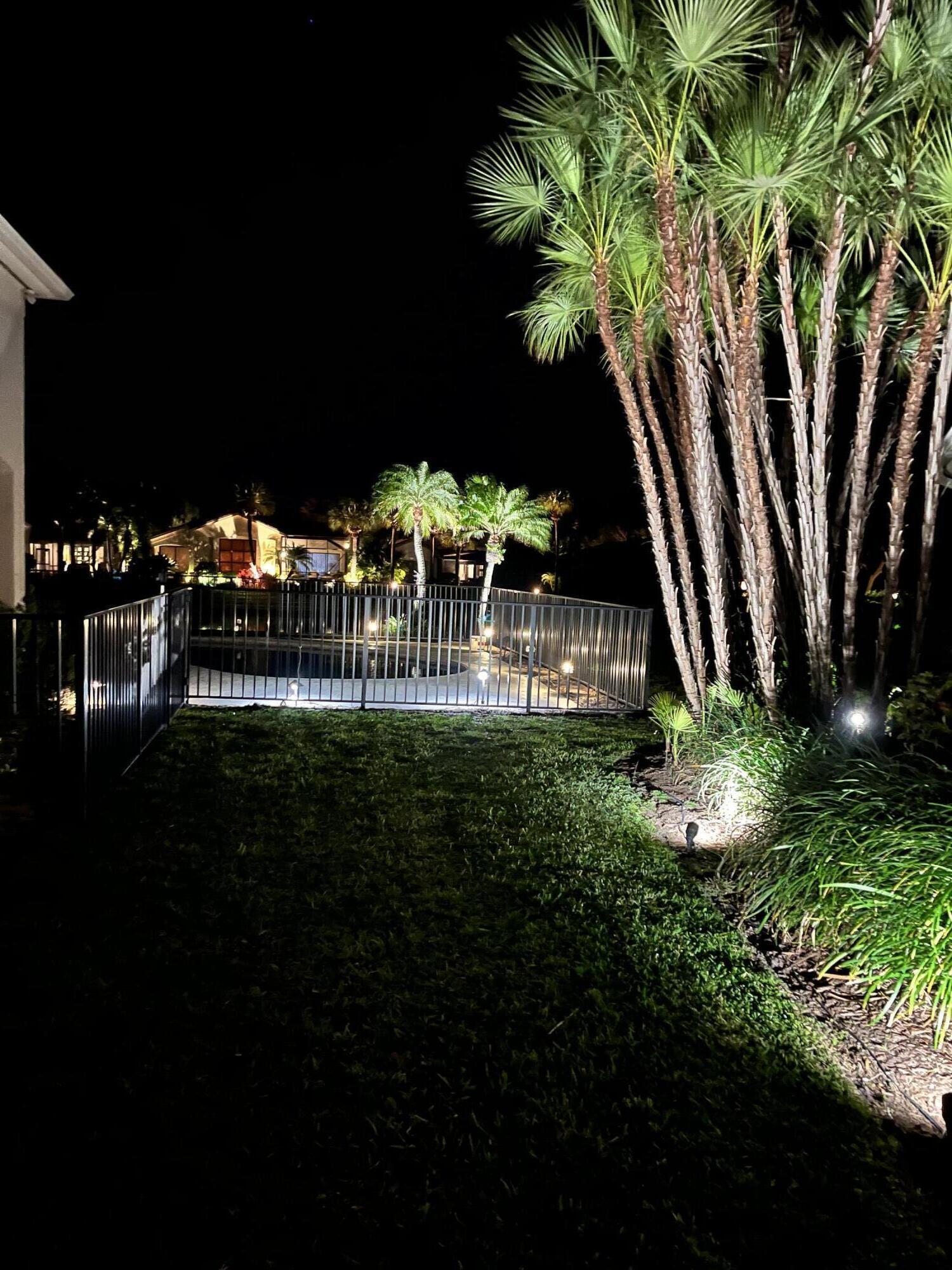 15810 Windrift Drive Jupiter, FL 33477 - Photo 22 of 52 a garden view with a seating space