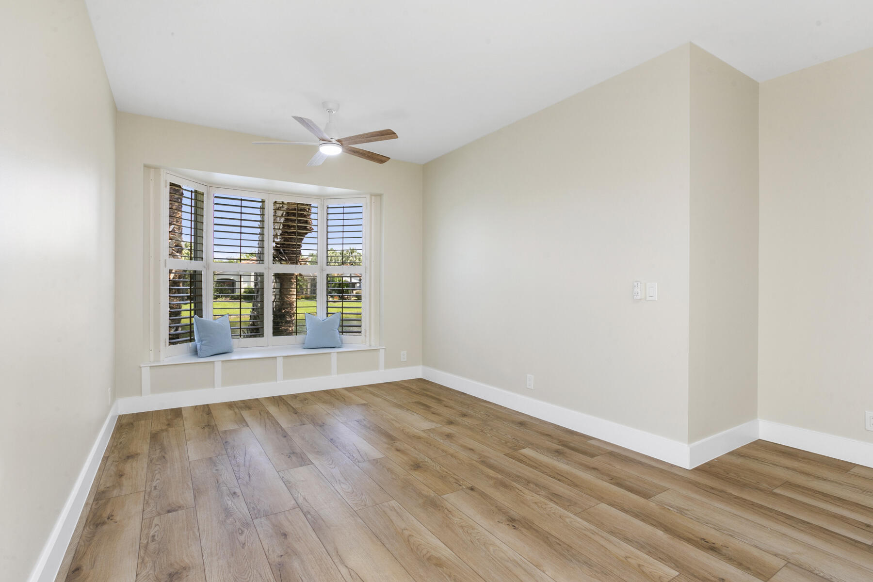 15810 Windrift Drive Jupiter, FL 33477 - Photo 25 of 52 a view of an empty room with wooden floor and a window