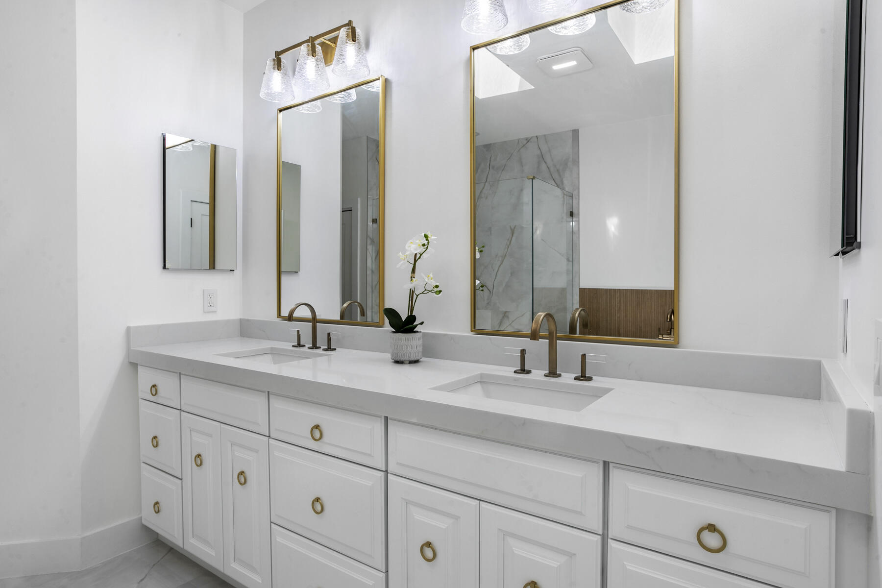 15810 Windrift Drive Jupiter, FL 33477 - Photo 30 of 52 a bathroom with double sink and a mirror