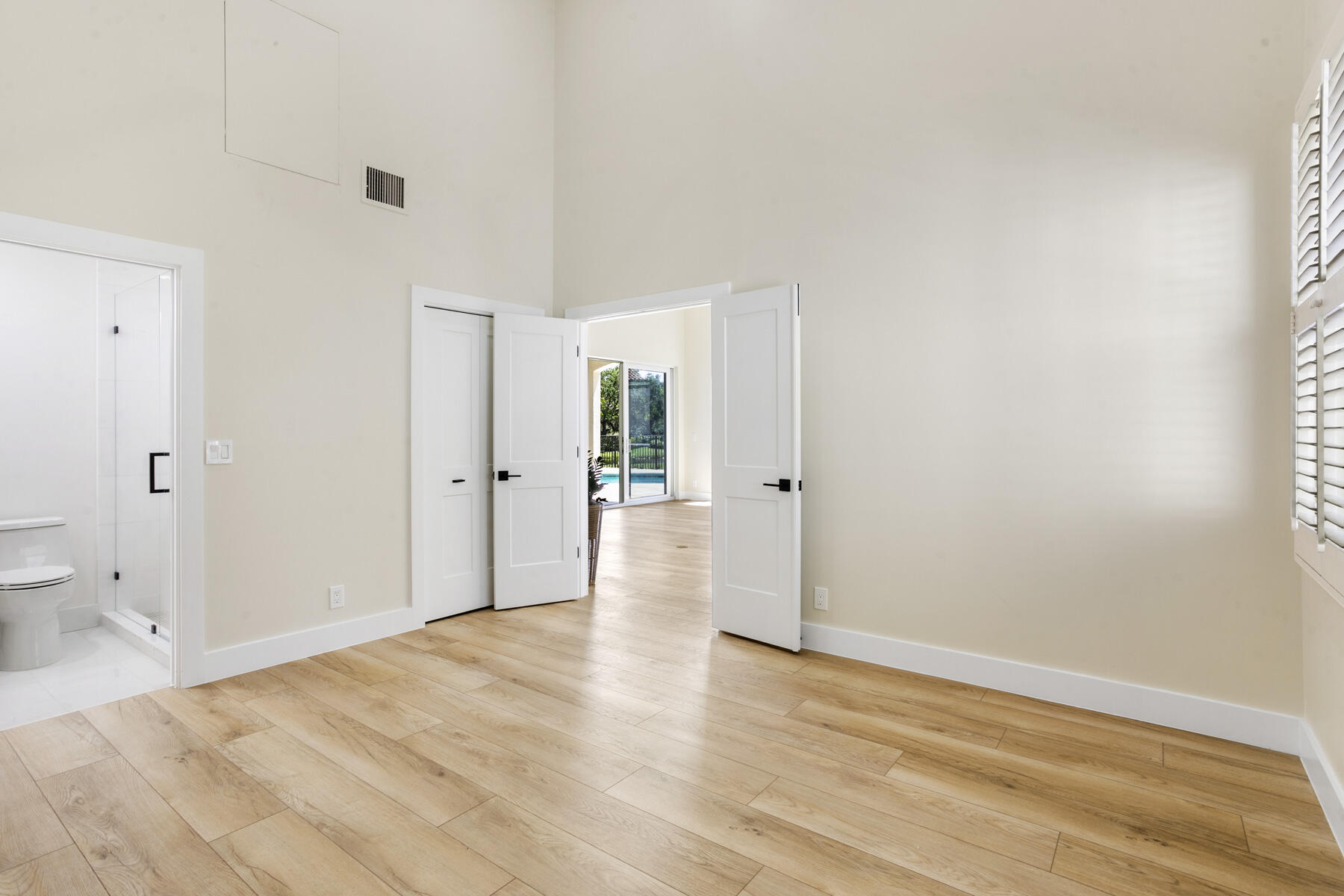 15810 Windrift Drive Jupiter, FL 33477 - Photo 34 of 52 a view of a big room with wooden floor and a bathroom