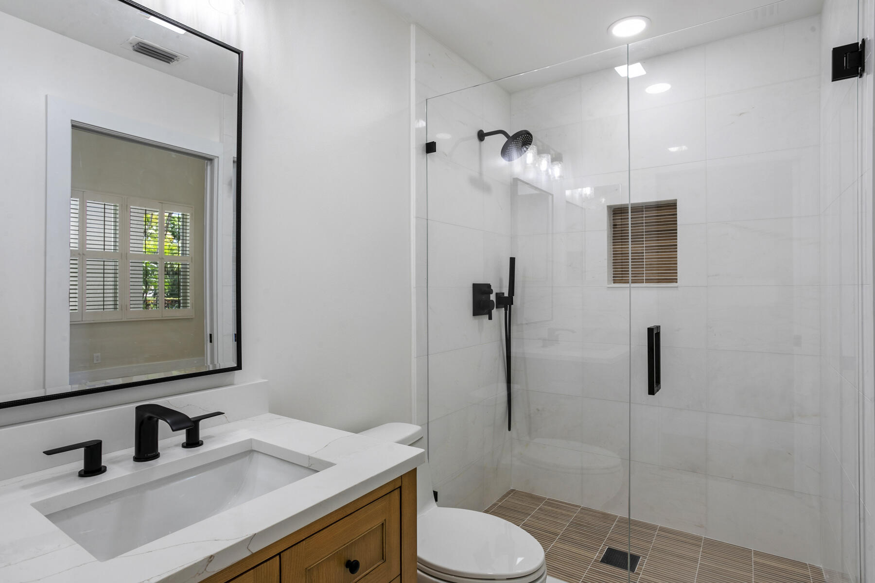 15810 Windrift Drive Jupiter, FL 33477 - Photo 36 of 52 a bathroom with a sink toilet and shower