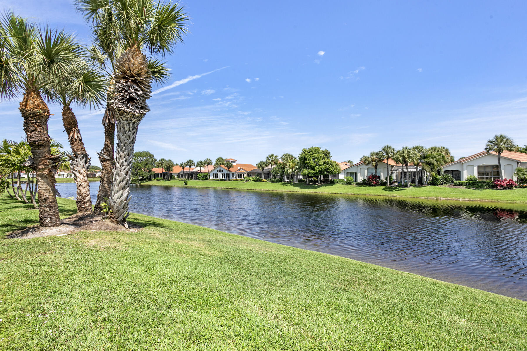 15810 Windrift Drive Jupiter, FL 33477 - Photo 38 of 52 a view of a lake with a building in the background