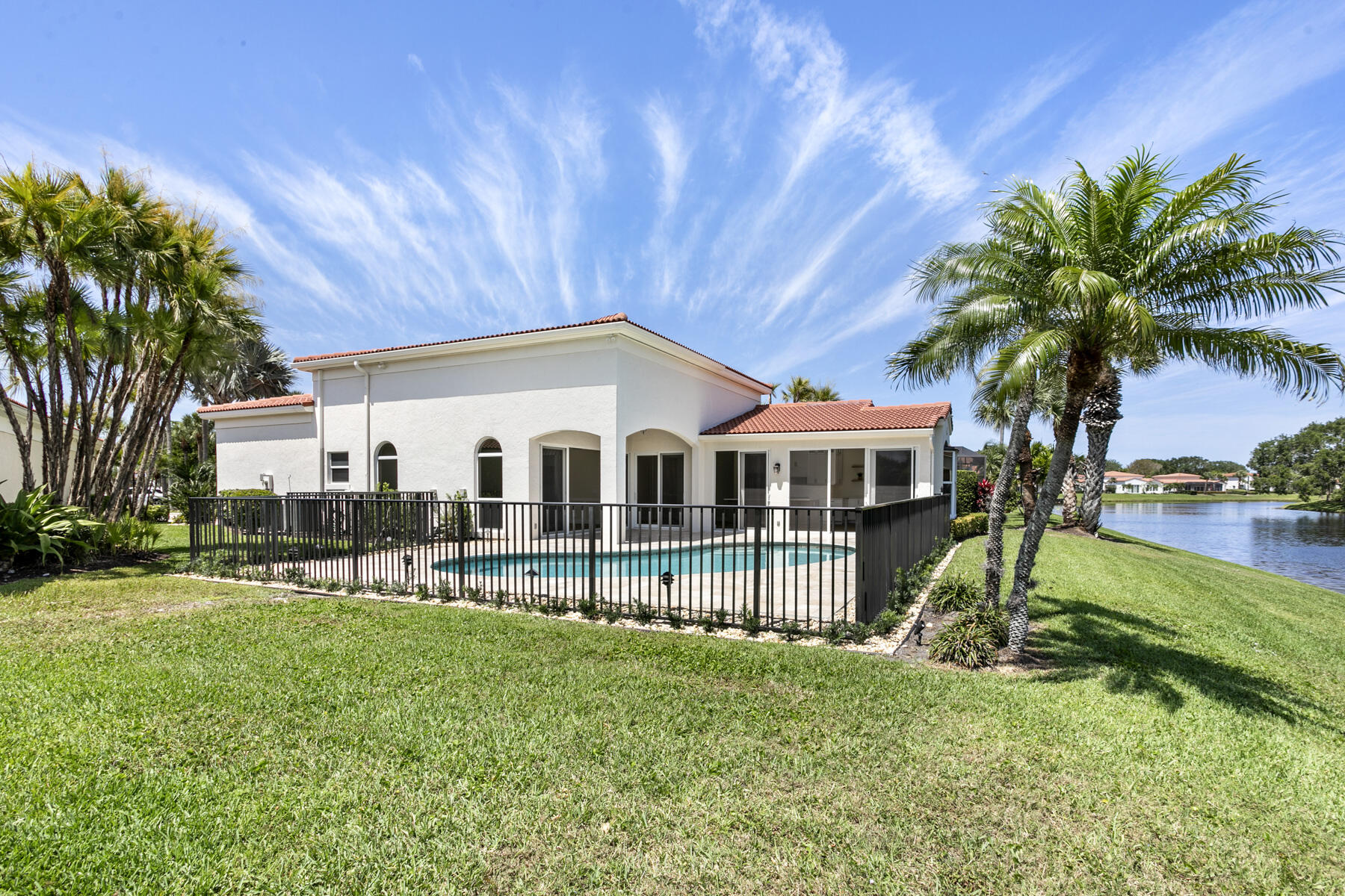 15810 Windrift Drive Jupiter, FL 33477 - Photo 39 of 52 a view of a house with a yard patio and swimming pool