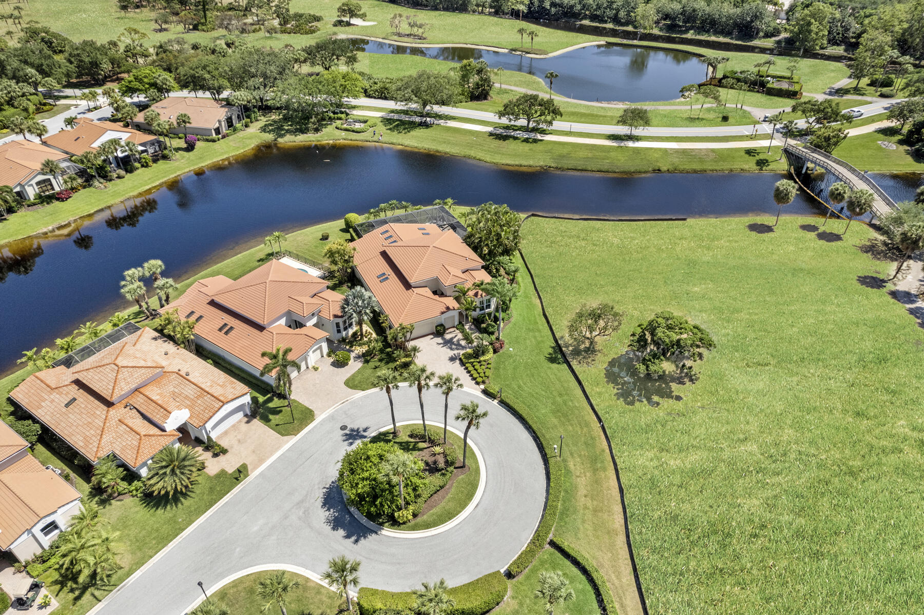 15810 Windrift Drive Jupiter, FL 33477 - Photo 48 of 52 an aerial view of a swimming pool with a yard
