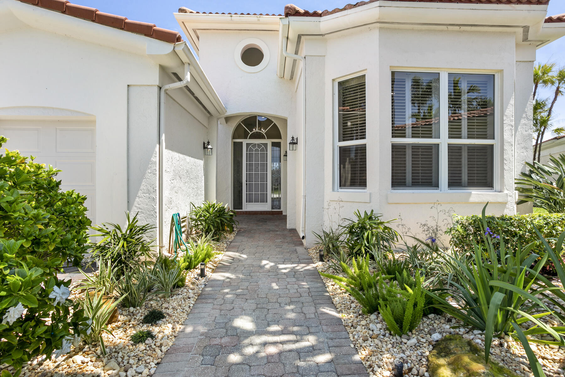 15810 Windrift Drive Jupiter, FL 33477 - Photo 5 of 52 front view of a house