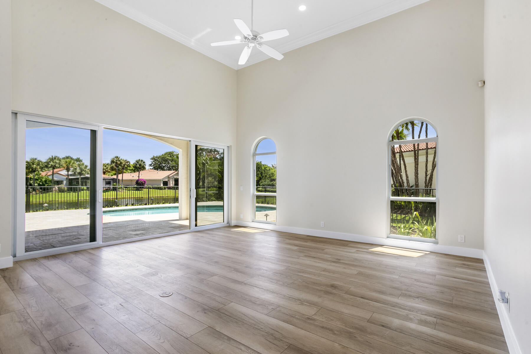 15810 Windrift Drive Jupiter, FL 33477 - Photo 6 of 52 a view of an empty room with window wooden floor