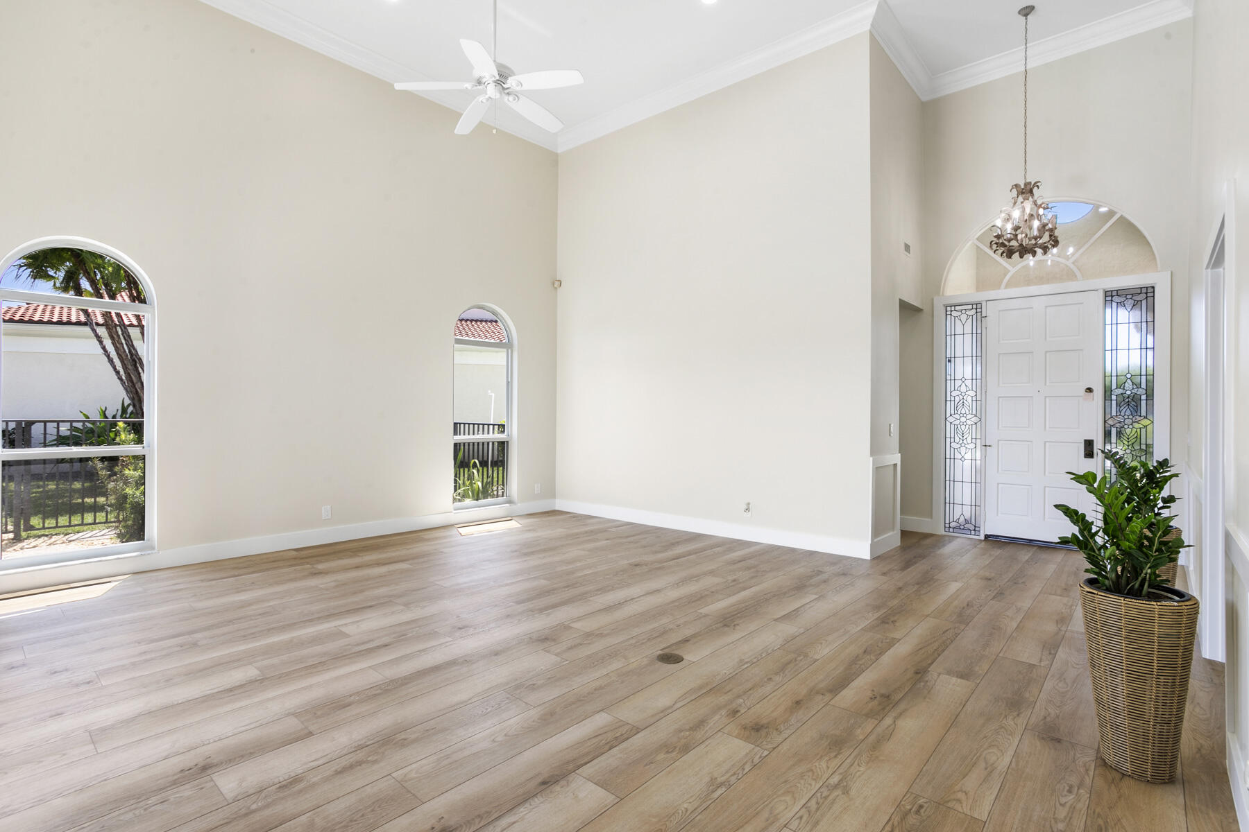 15810 Windrift Drive Jupiter, FL 33477 - Photo 7 of 52 a view of an empty room with wooden floor and a window