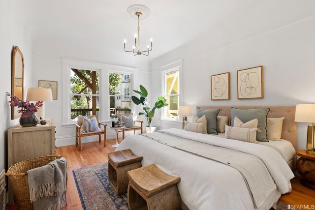a bedroom with a bed mirror and window