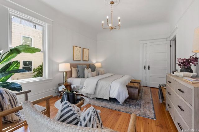 a bed room with a bed and a chair