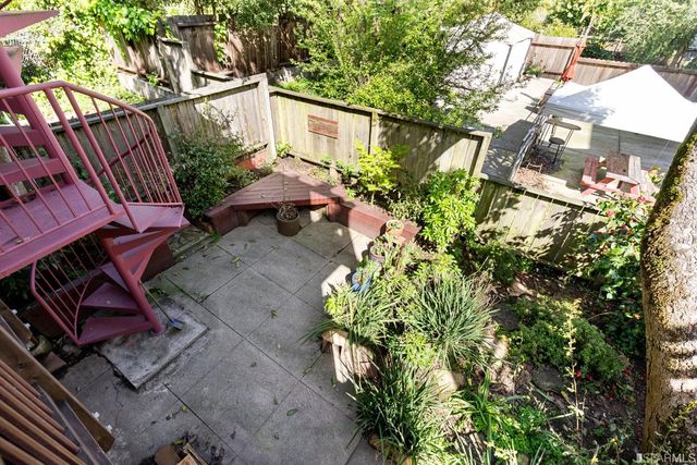 a white house with lots of plants