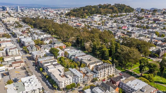 an aerial view of residential houses with city view