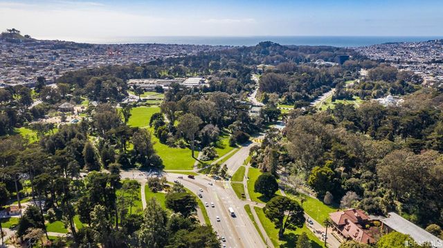an aerial view of residential house with swimming pool and green space