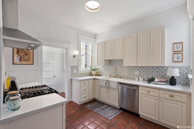 a kitchen with a sink stove and cabinets