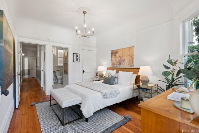 a bedroom with a bed and a chandelier