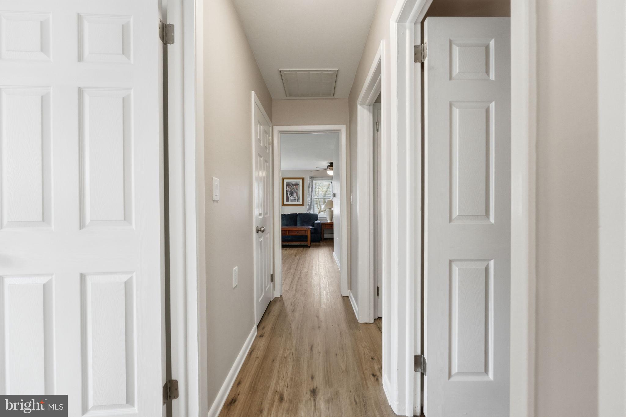 1717 Pennrock Road Wilmington, DE 19809 - Photo 17 of 41 a view of a hallway with wooden floor and staircase