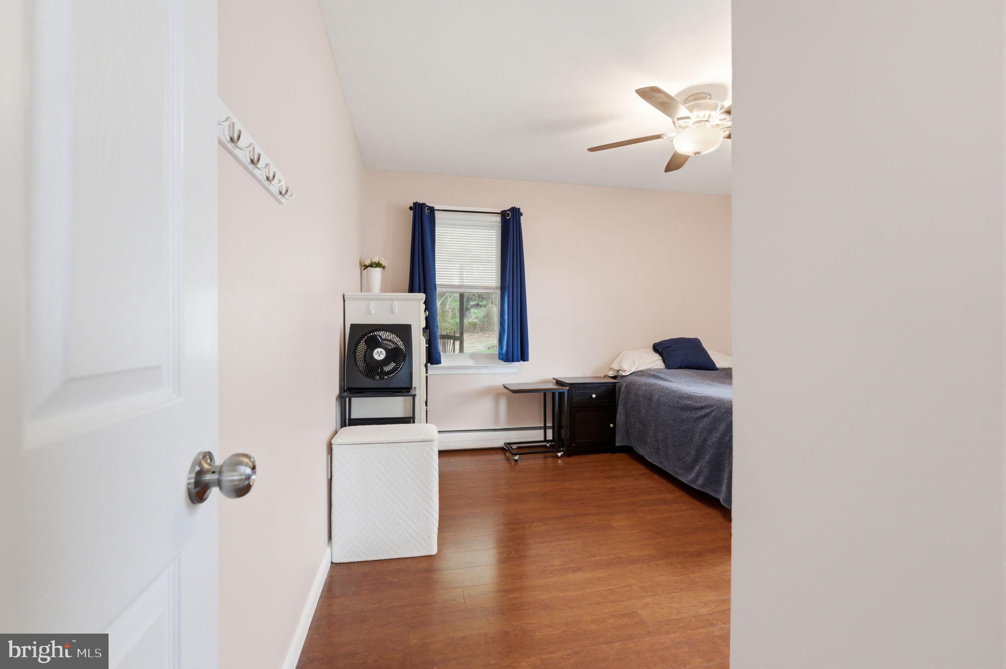 1717 Pennrock Road Wilmington, DE 19809 - Photo 20 of 41 a bedroom with a bed and a chandelier