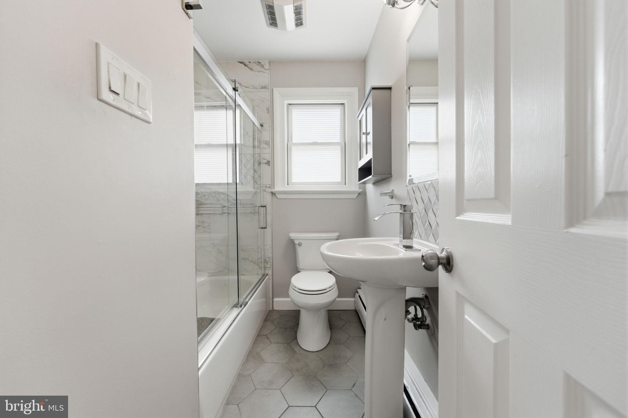 1717 Pennrock Road Wilmington, DE 19809 - Photo 23 of 41 a bathroom with a toilet sink and mirror