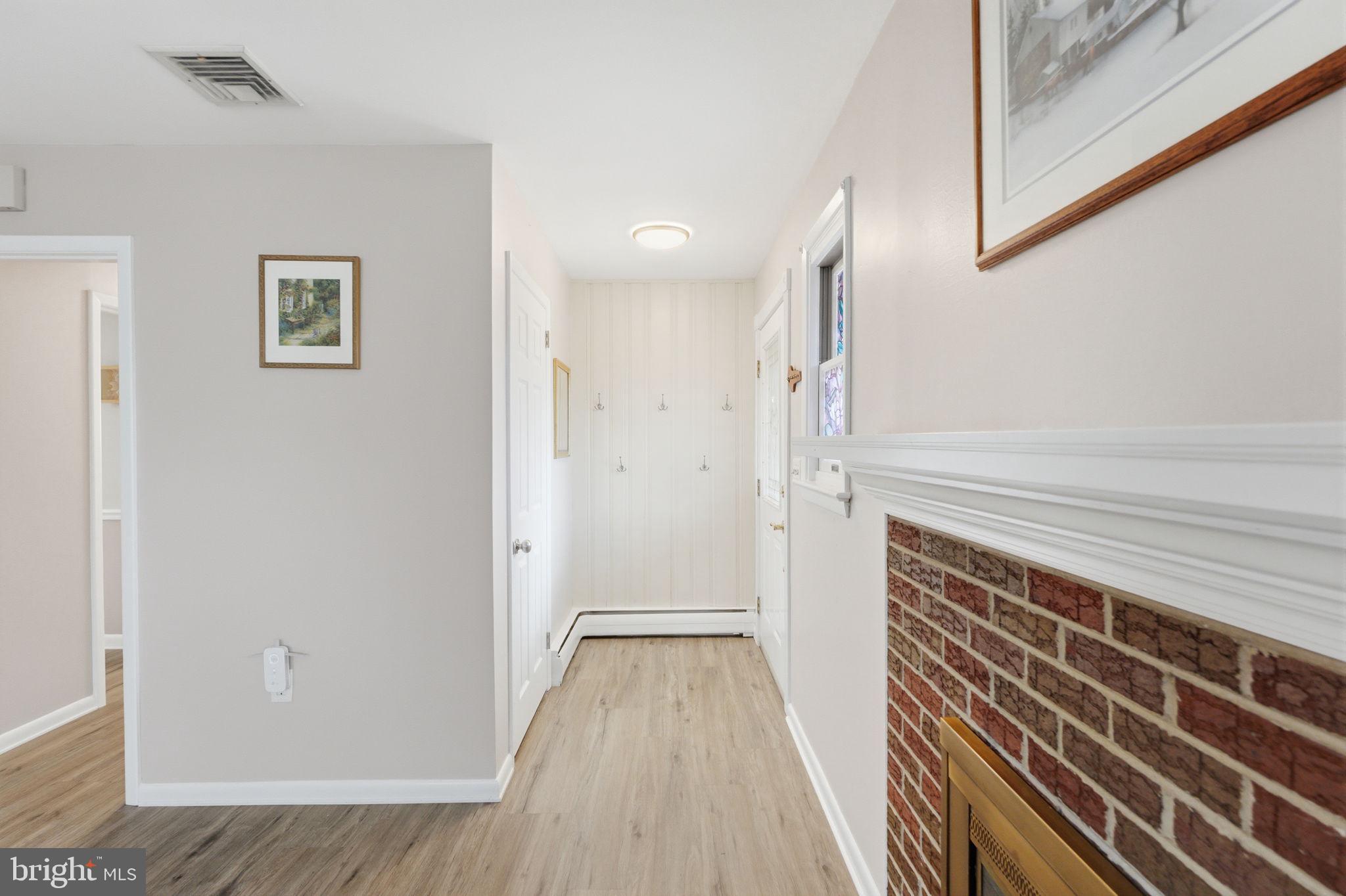 1717 Pennrock Road Wilmington, DE 19809 - Photo 3 of 41 a view of a hallway with wooden floor and staircase