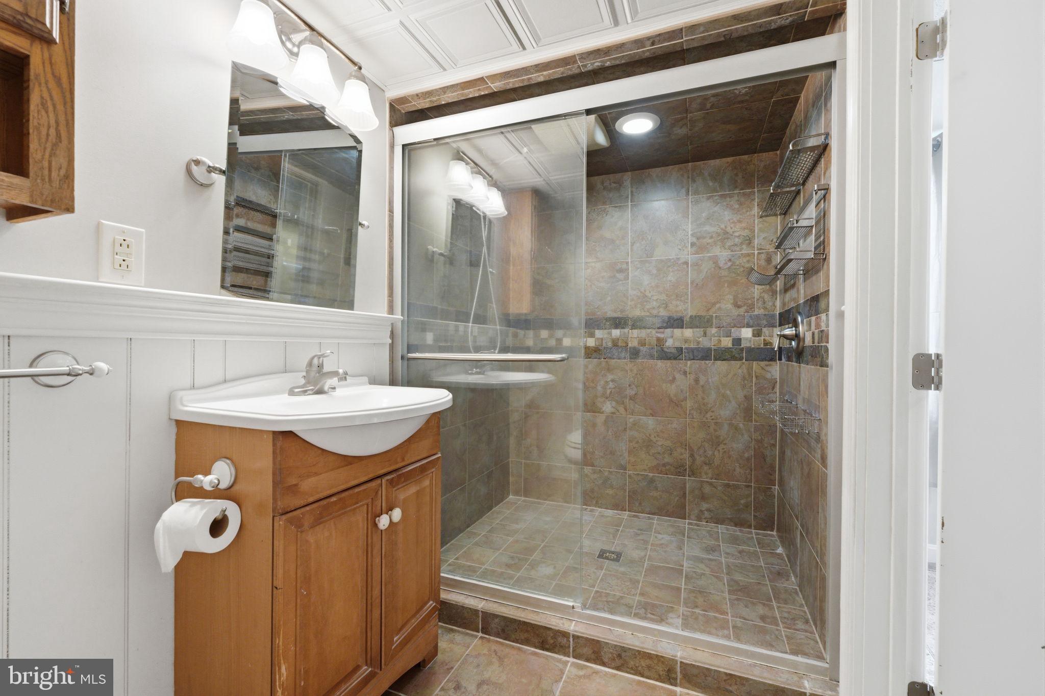 1717 Pennrock Road Wilmington, DE 19809 - Photo 32 of 41 a bathroom with a shower and mirror