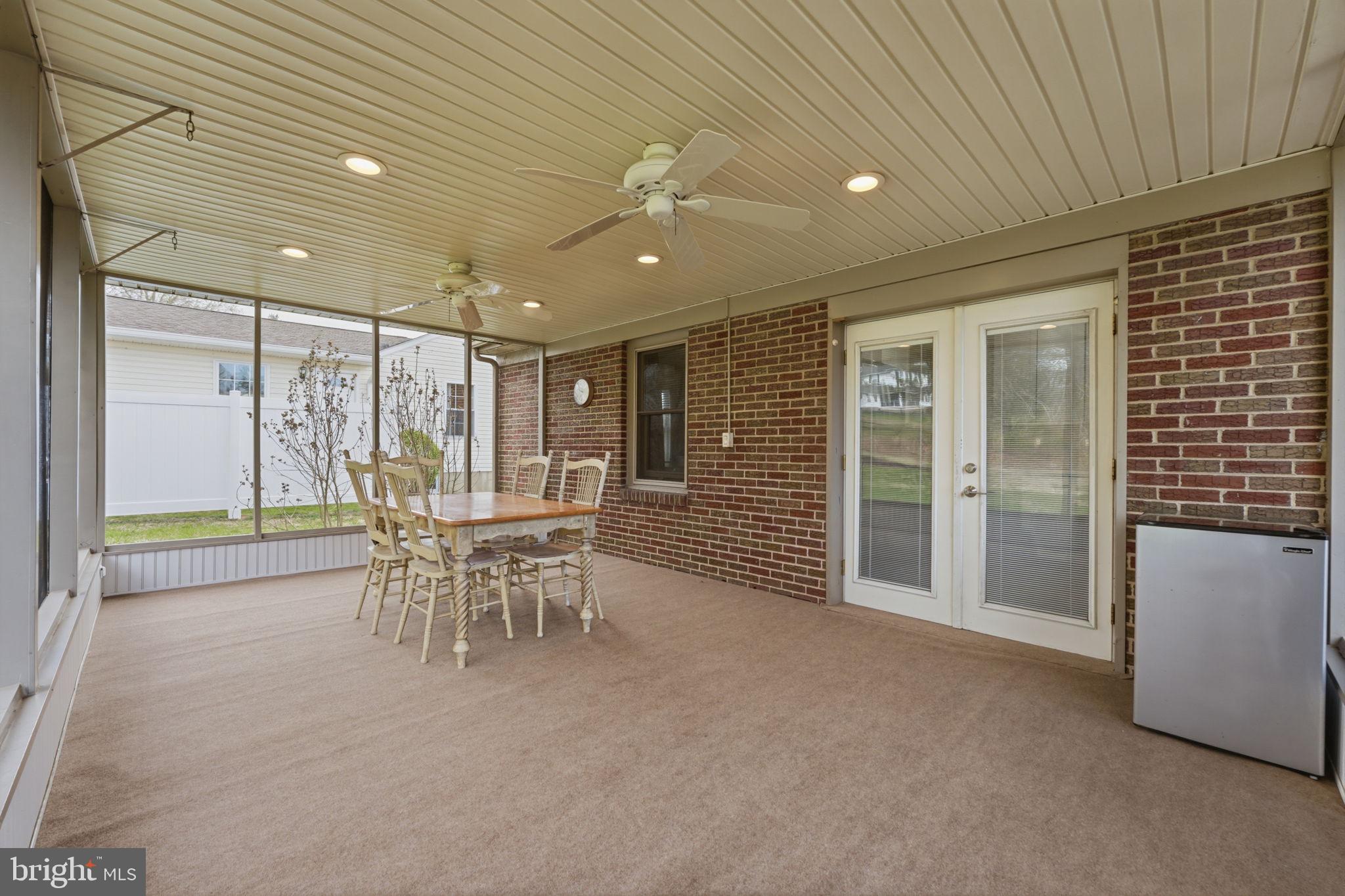 1717 Pennrock Road Wilmington, DE 19809 - Photo 36 of 41 a dining room with furniture and a floor to ceiling window