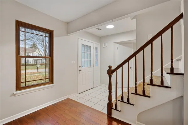 a view of an entryway with wooden floor and door