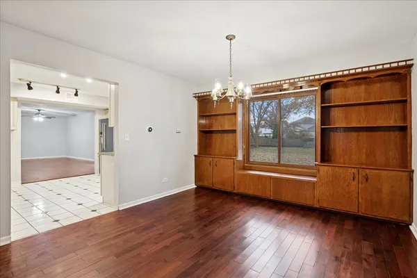 a view of a livingroom with wooden floor and cabinet