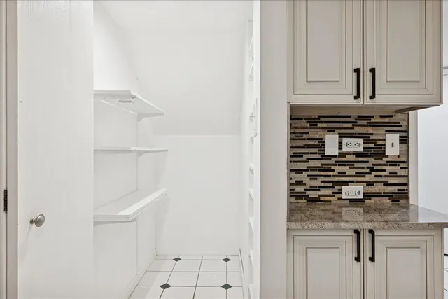 a kitchen with white cabinets and appliances