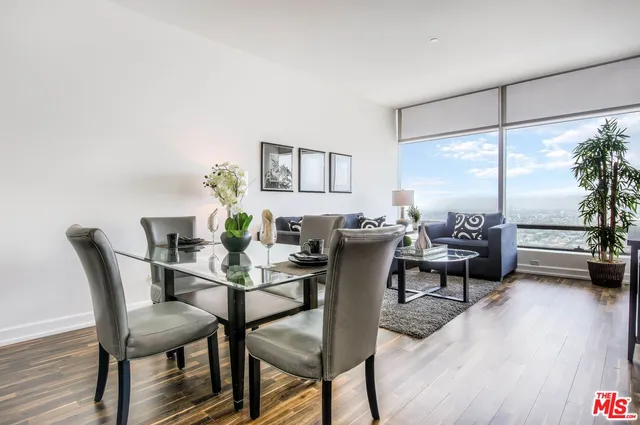 a view of a dining room with furniture and a wooden floor