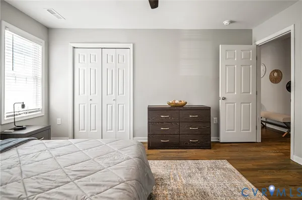 a bedroom with a bed and a dresser
