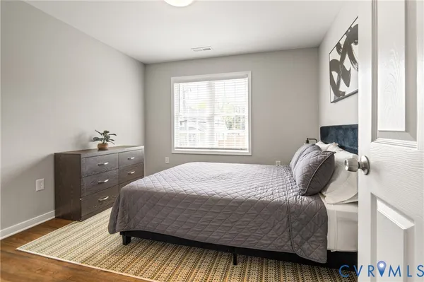 a bedroom with a bed and wooden floor