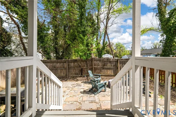 a view of a balcony with wooden floor and fence