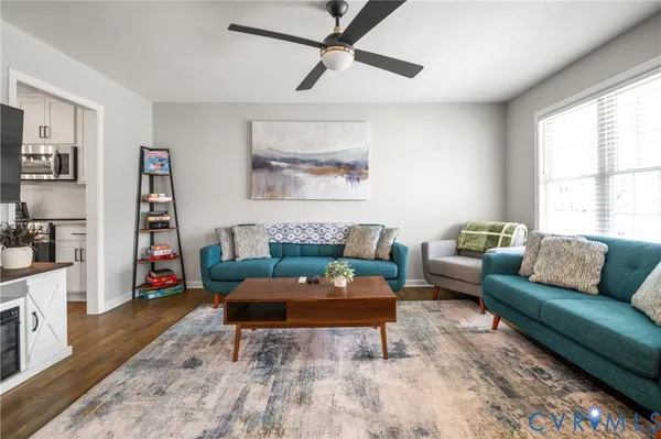 a living room with furniture a rug and a window