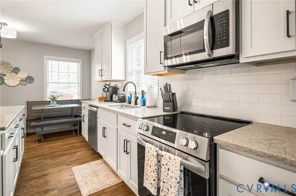 a kitchen with a stove microwave and sink