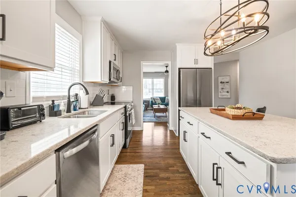 a kitchen with stainless steel appliances granite countertop a sink and dishwasher