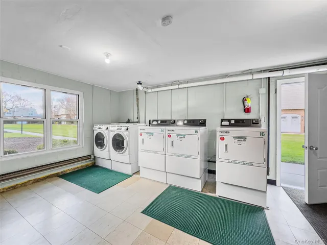 a utility room with cabinets and washer