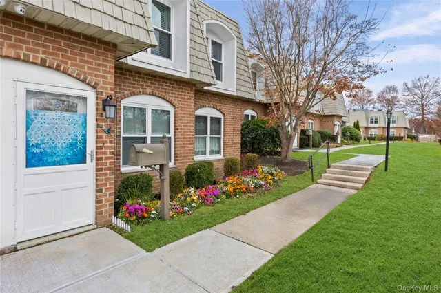 a view of a house with a yard and garden