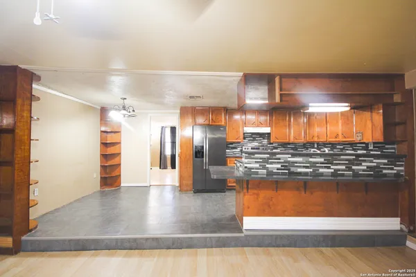 a kitchen with stainless steel appliances granite countertop a refrigerator and a stove