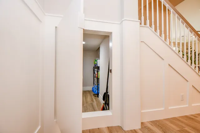 a view of a hallway with wooden floor and entryway