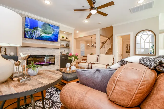 a living room with furniture a fireplace and a flat screen tv
