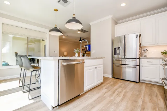 a kitchen with appliances cabinets and furniture