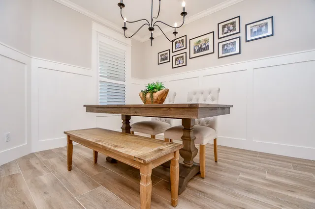 a view of a table and chairs in wooden floor